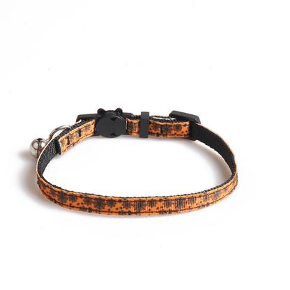 Orange cat collar with black spiderweb print, cat-face clasp and bell