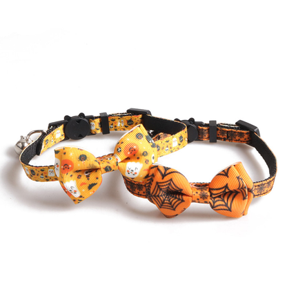 Pumpkin-and-ghost and spiderweb bow cat collars displayed together
