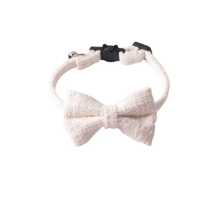 White textured cat collar with bow, bell and cat-face buckle