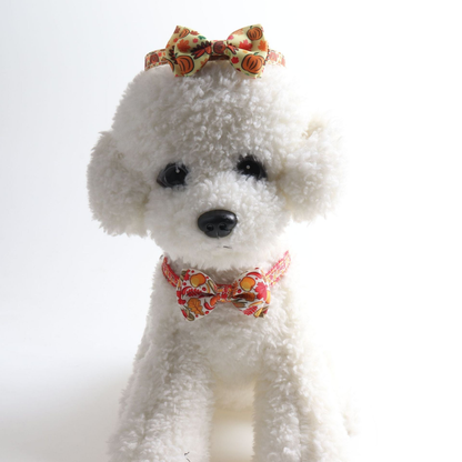 White dog model styled with two autumn-print bow cat collars
