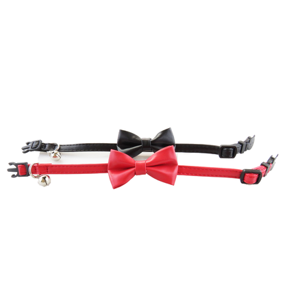 Red and black bow cat collars laid flat to show adjustable straps