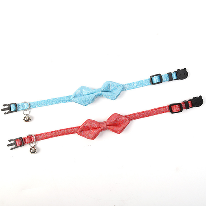 Light blue and red glitter bow cat collars laid flat to show their adjustable straps