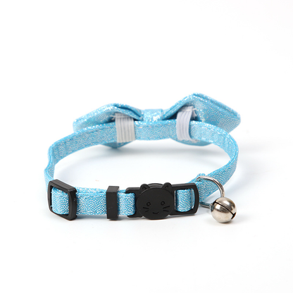 Light blue glitter bow cat collar showing the cat-face buckle, adjustment slider, D-ring and bell