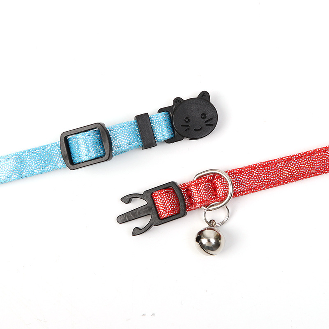 Close-up of the cat-face buckle, two-prong clasp, adjustment slider, D-ring and bell