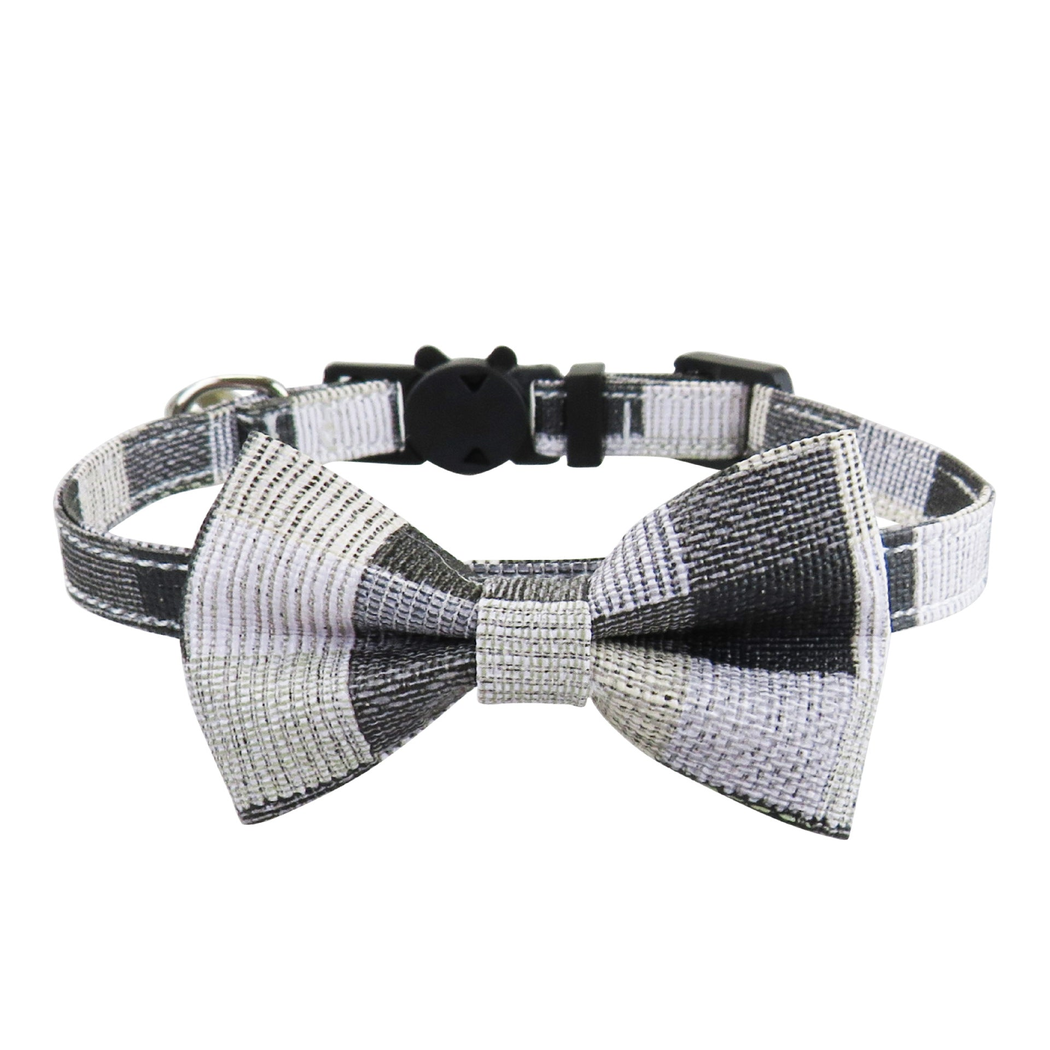 Black-and-white patchwork cat collar with bow and bell