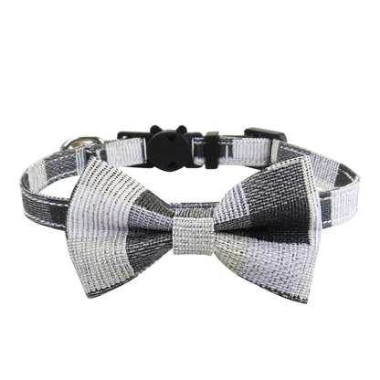 Black-and-white patchwork cat collar with bow and bell