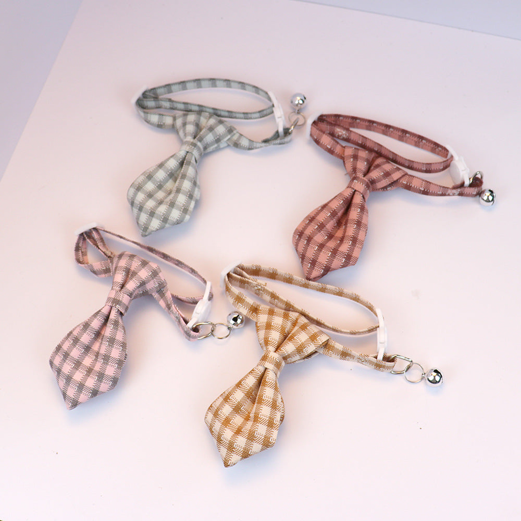 Four plaid cat collars with necktie-shaped bows and silver-tone bells