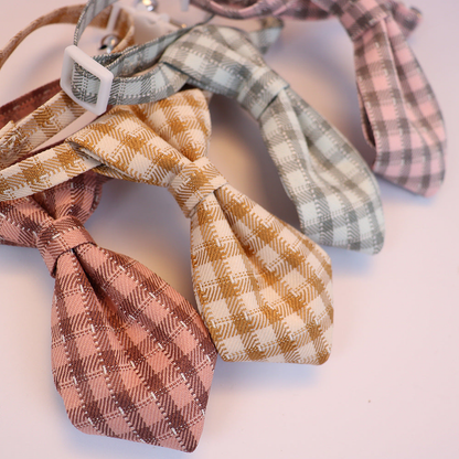 Close-up of plaid necktie-shaped bows with fine metallic-look accent lines