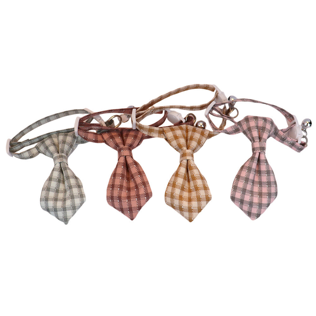 Four plaid cat collars displayed in a row with pointed necktie-shaped bows