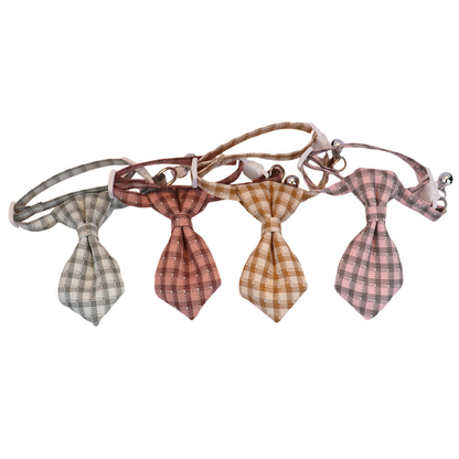 Four plaid cat collars displayed in a row with pointed necktie-shaped bows