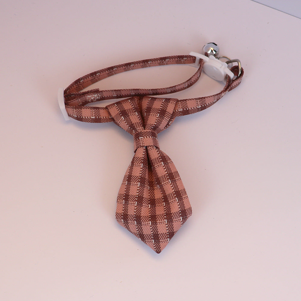Dusty rose plaid cat collar with necktie-shaped bow, white buckle and silver-tone bell