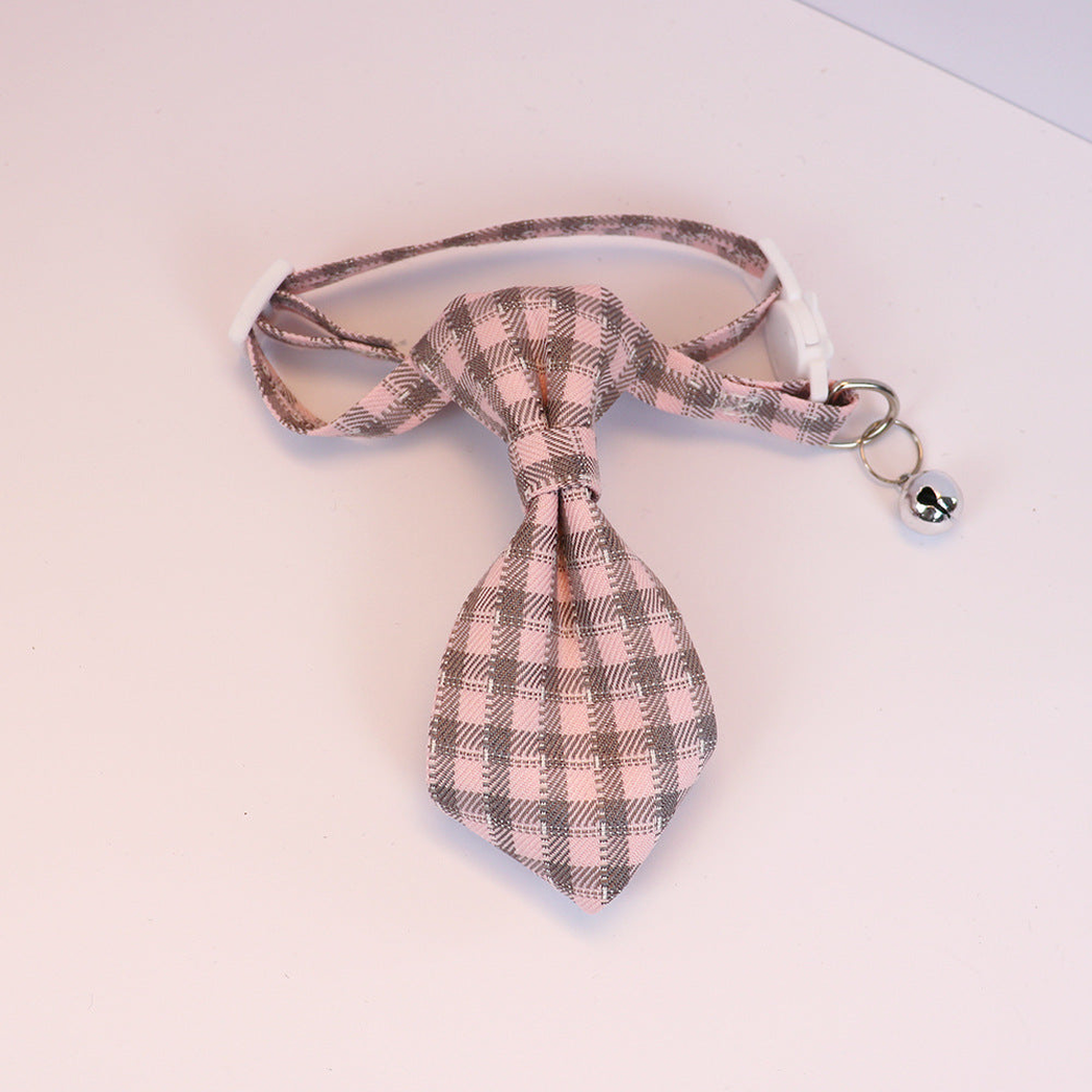 Light pink and gray plaid cat collar with necktie-shaped bow and silver-tone bell