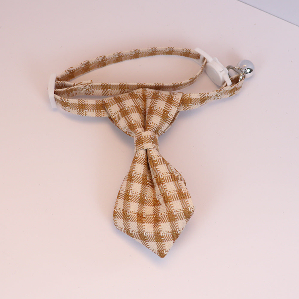 Mustard yellow plaid cat collar with necktie-shaped bow, white buckle and silver-tone bell