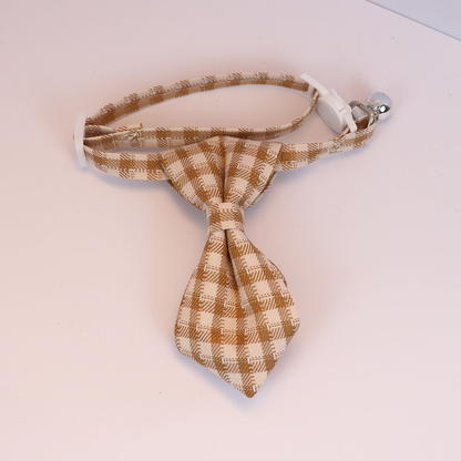 Mustard yellow plaid cat collar with necktie-shaped bow, white buckle and silver-tone bell