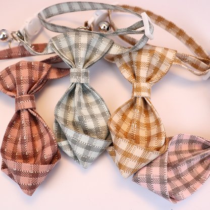 Close-up of four plaid necktie-shaped collar bows with folded pointed ends