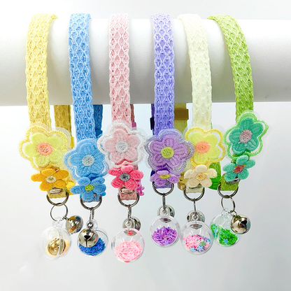 Six flower cat collars displayed with bells and clear star-filled charms
