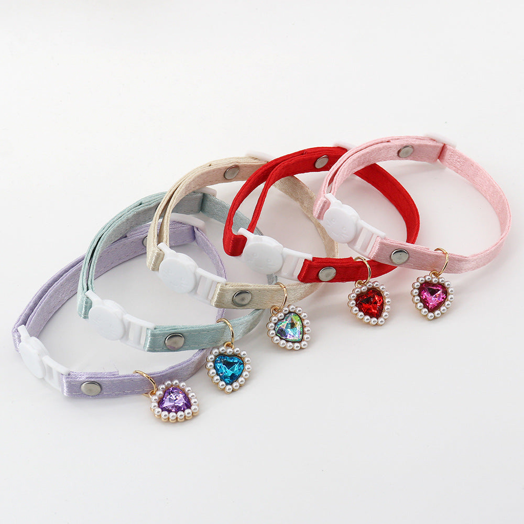 Five colorful cat collars with cat-face buckles and dangling heart charms
