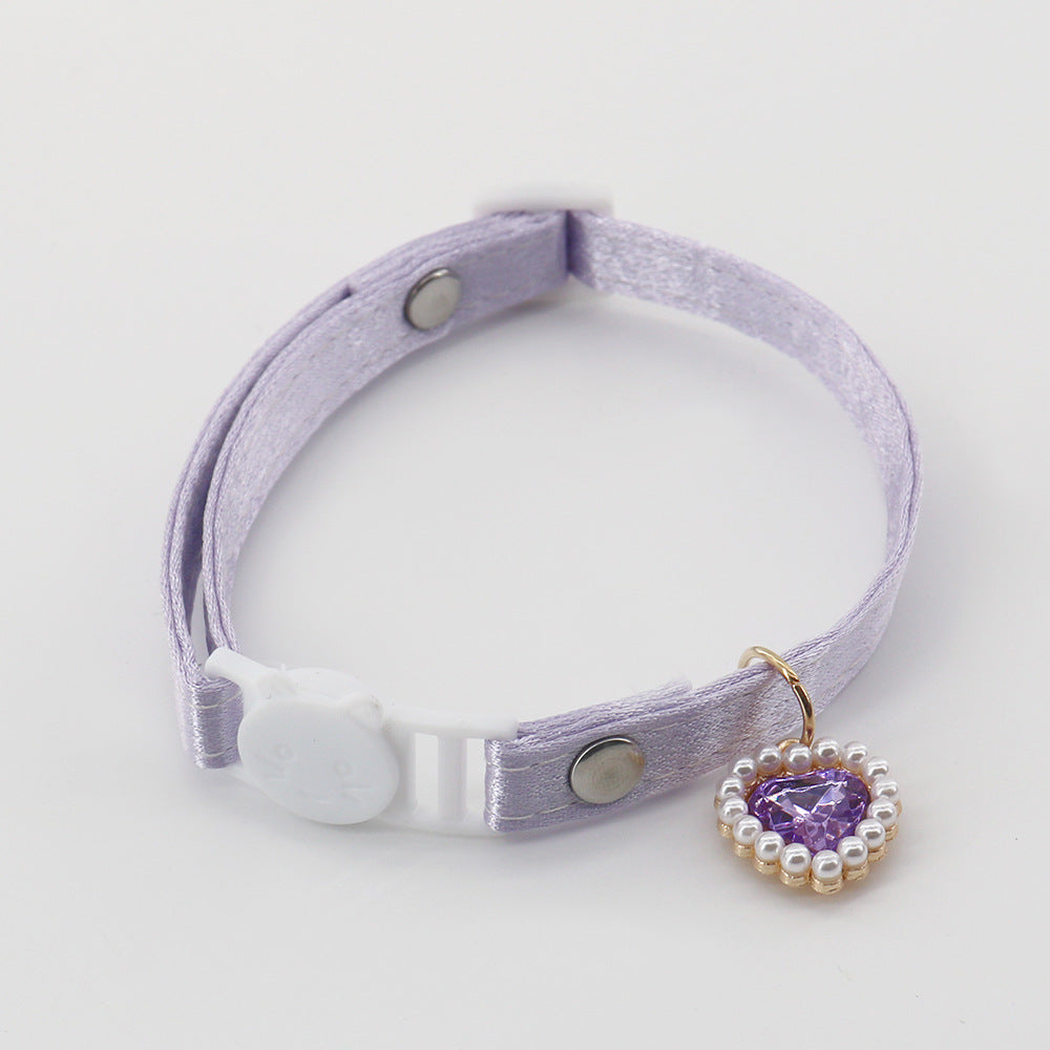 Light purple cat collar with a cat-face buckle and matching heart charm