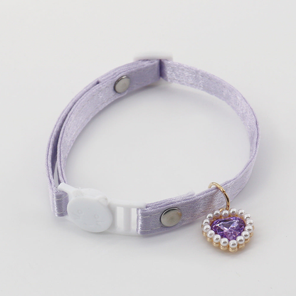 Light purple cat collar with a cat-face buckle and matching heart charm