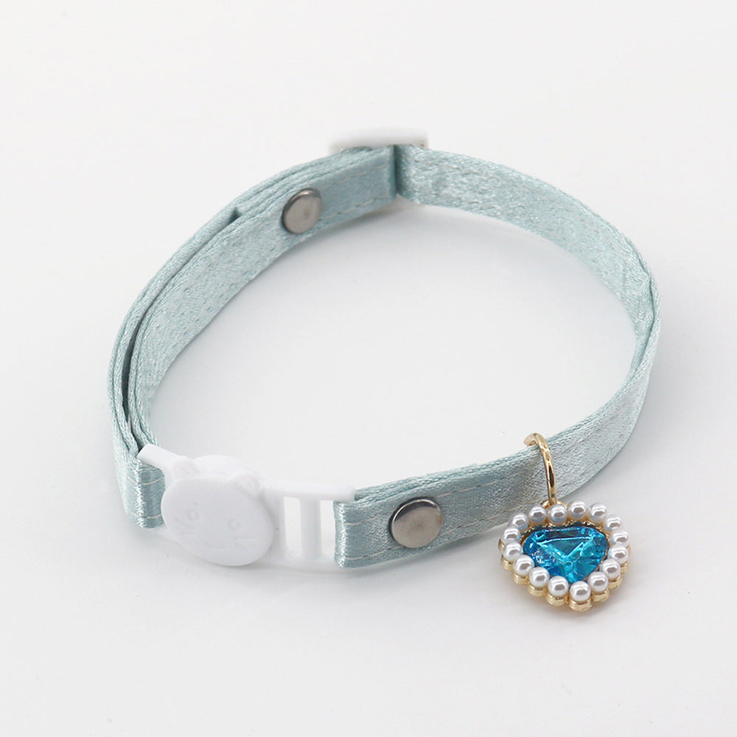 Light blue-green cat collar with a cat-face buckle and blue heart charm
