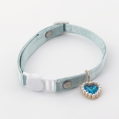 Light blue-green cat collar with a cat-face buckle and blue heart charm