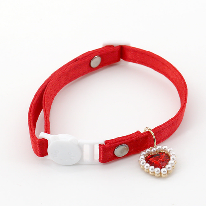 Red cat collar with a cat-face buckle and red heart charm