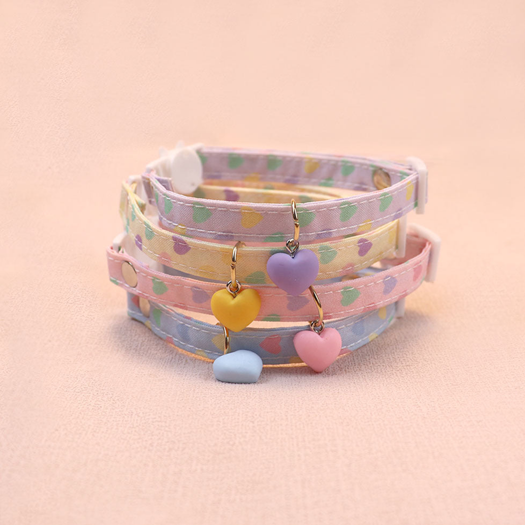 Four pastel heart-print cat collars with matching heart charms