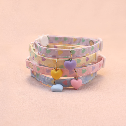 Four pastel heart-print cat collars with matching heart charms