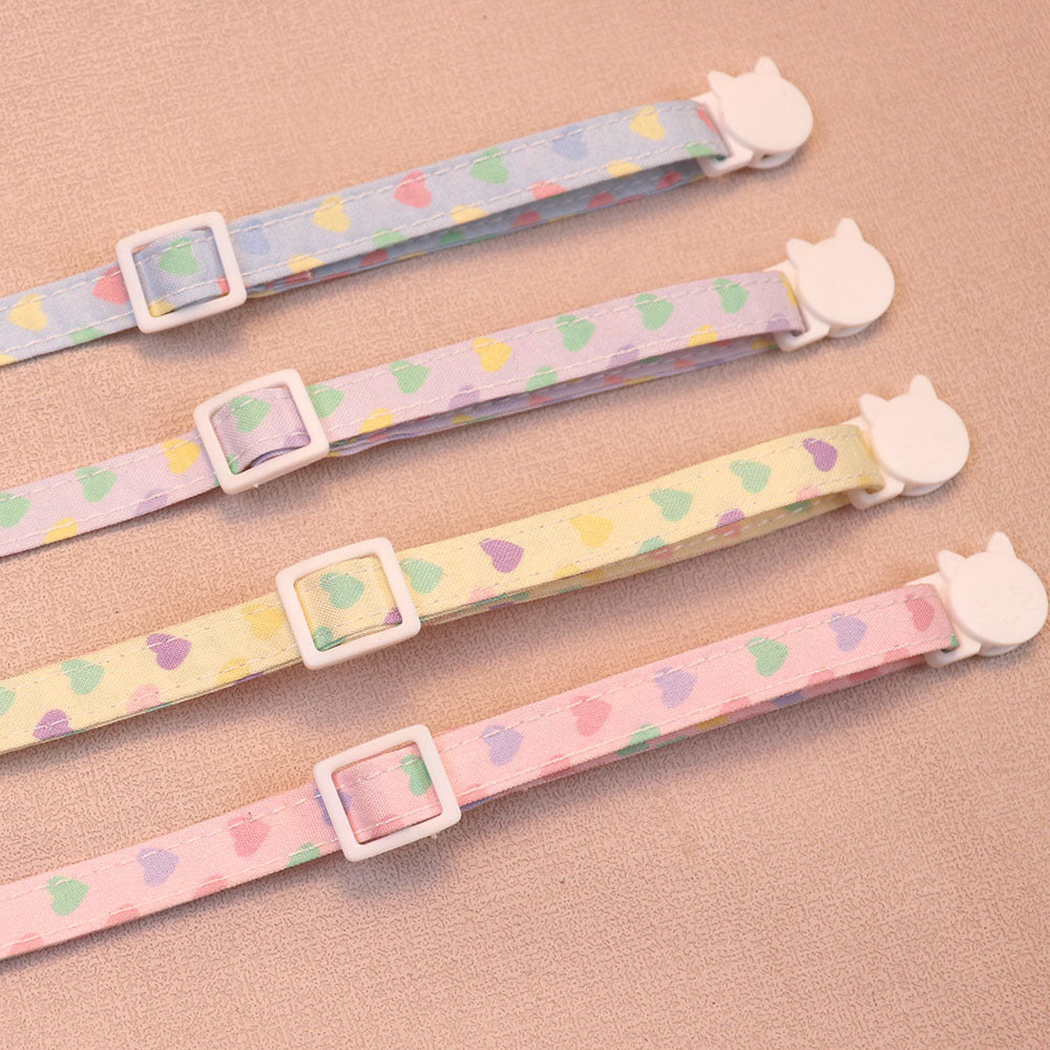 Close-up of the adjustable straps and cat-face buckles on four pastel cat collars