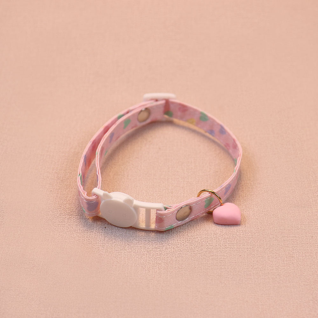 Pink heart-print cat collar with a pink heart charm and cat-face buckle