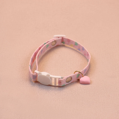 Pink heart-print cat collar with a pink heart charm and cat-face buckle