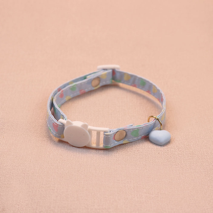 Light blue heart-print cat collar with a blue heart charm and cat-face buckle