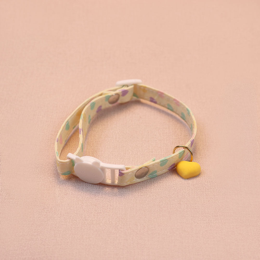 Yellow heart-print cat collar with a yellow heart charm and cat-face buckle