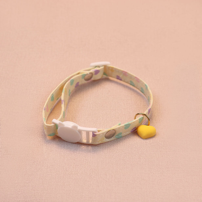 Yellow heart-print cat collar with a yellow heart charm and cat-face buckle