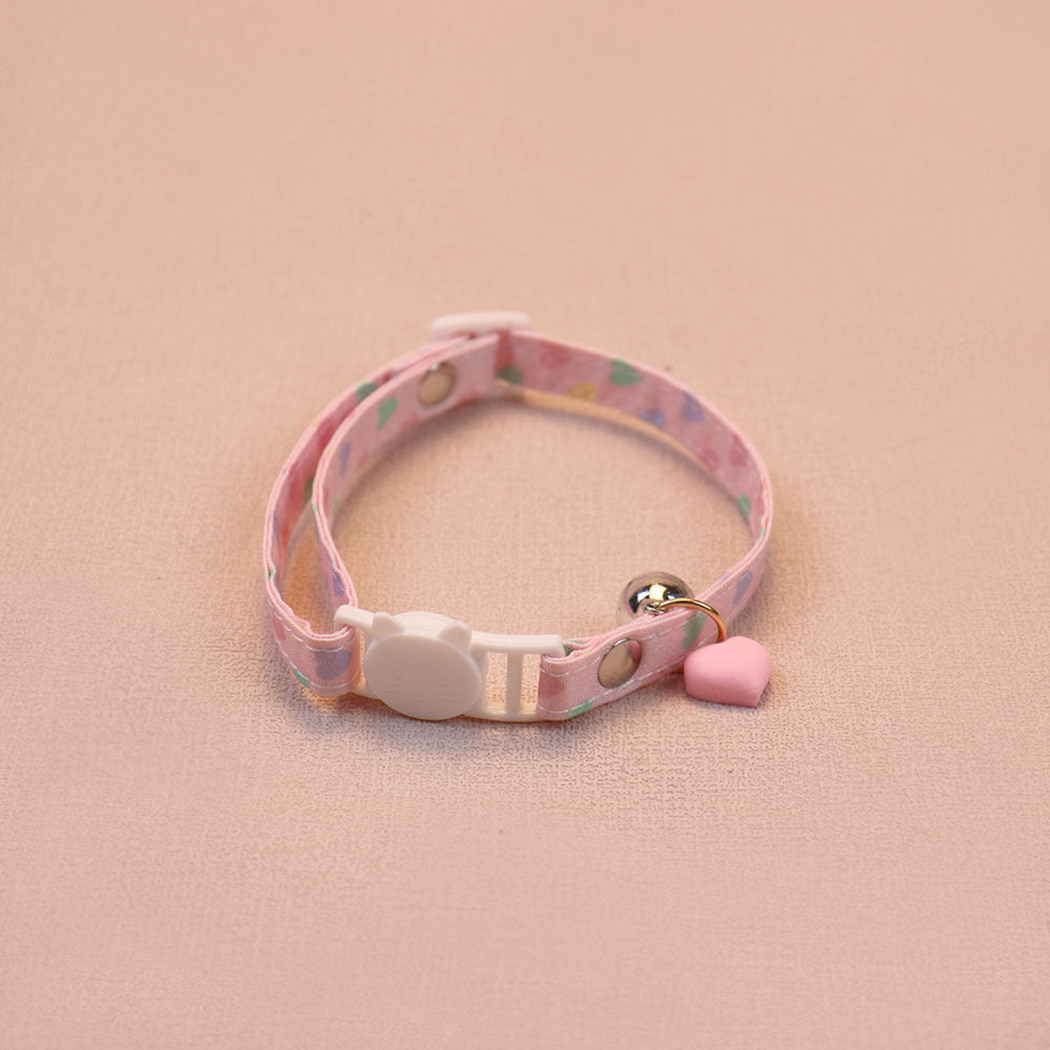 Pink heart-print cat collar with a pink heart charm, bell and cat-face buckle