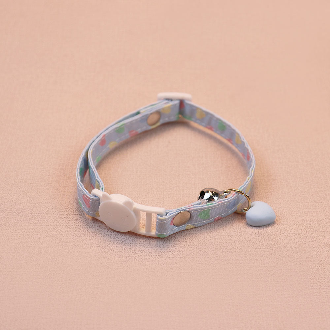 Light blue heart-print cat collar with a blue heart charm, bell and cat-face buckle