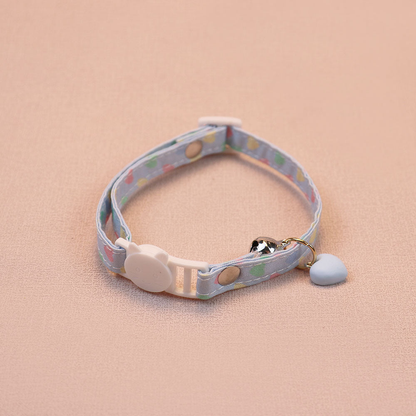 Light blue heart-print cat collar with a blue heart charm, bell and cat-face buckle