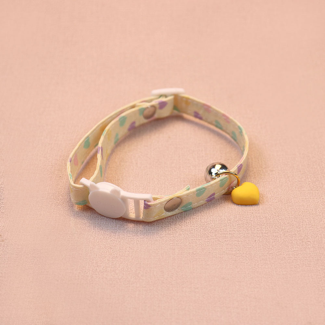 Yellow heart-print cat collar with a yellow heart charm, bell and cat-face buckle