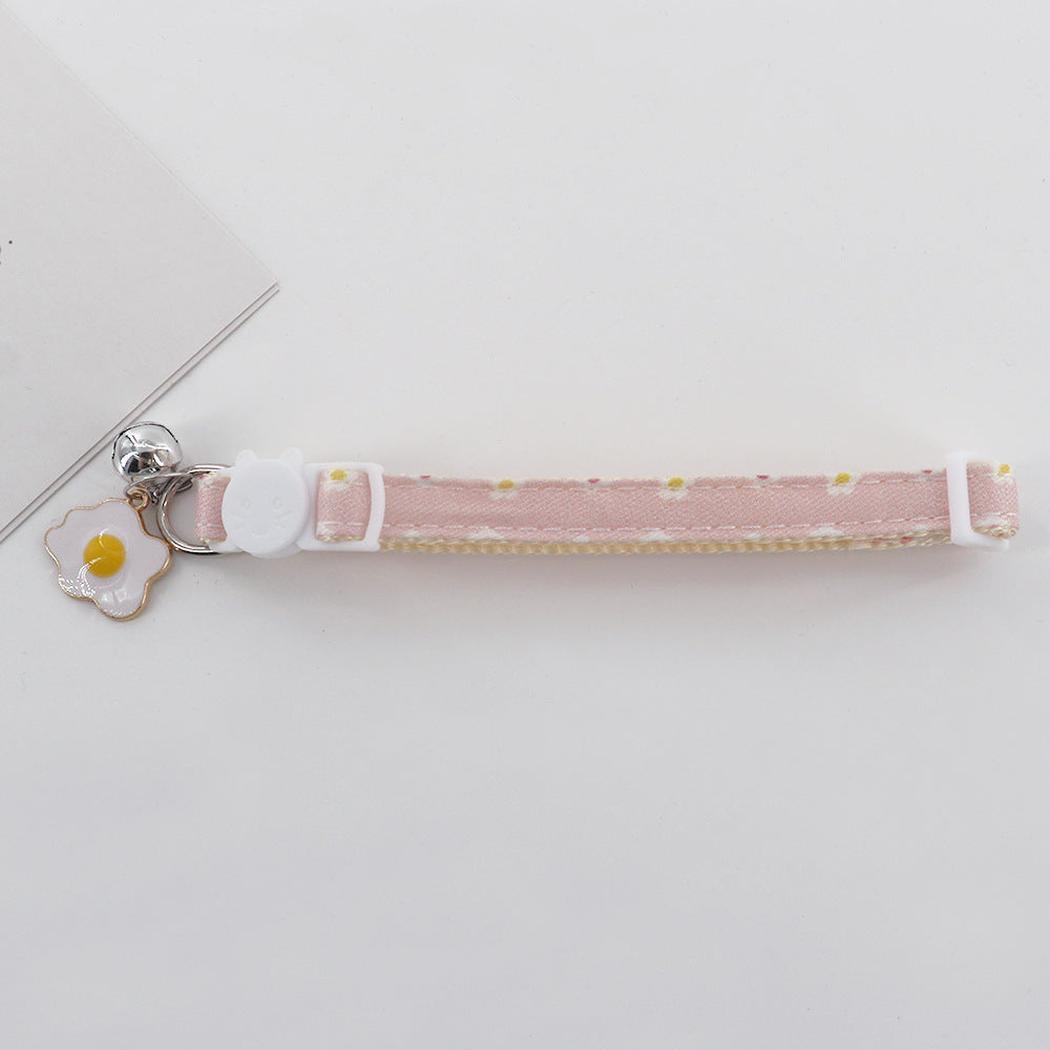 Light pink daisy cat collar with cat-face buckle, bell and fried egg charm