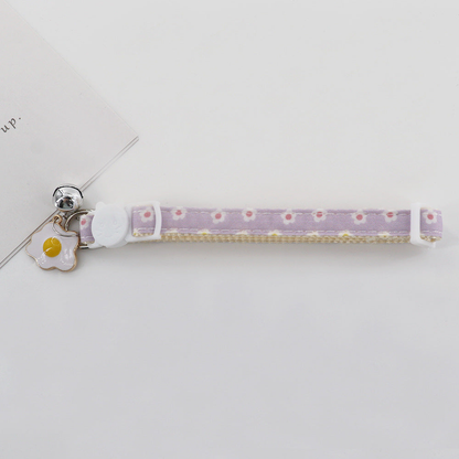 Light purple daisy cat collar with cat-face buckle, bell and fried egg charm