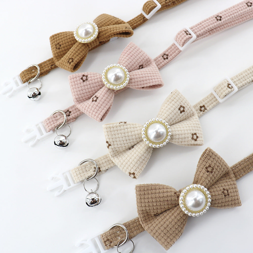 Close overview of four floral bow cat collars with pearl-look centers
