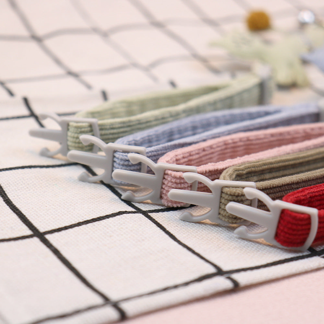Close-up of adjustable collar straps and gray cat-face buckles