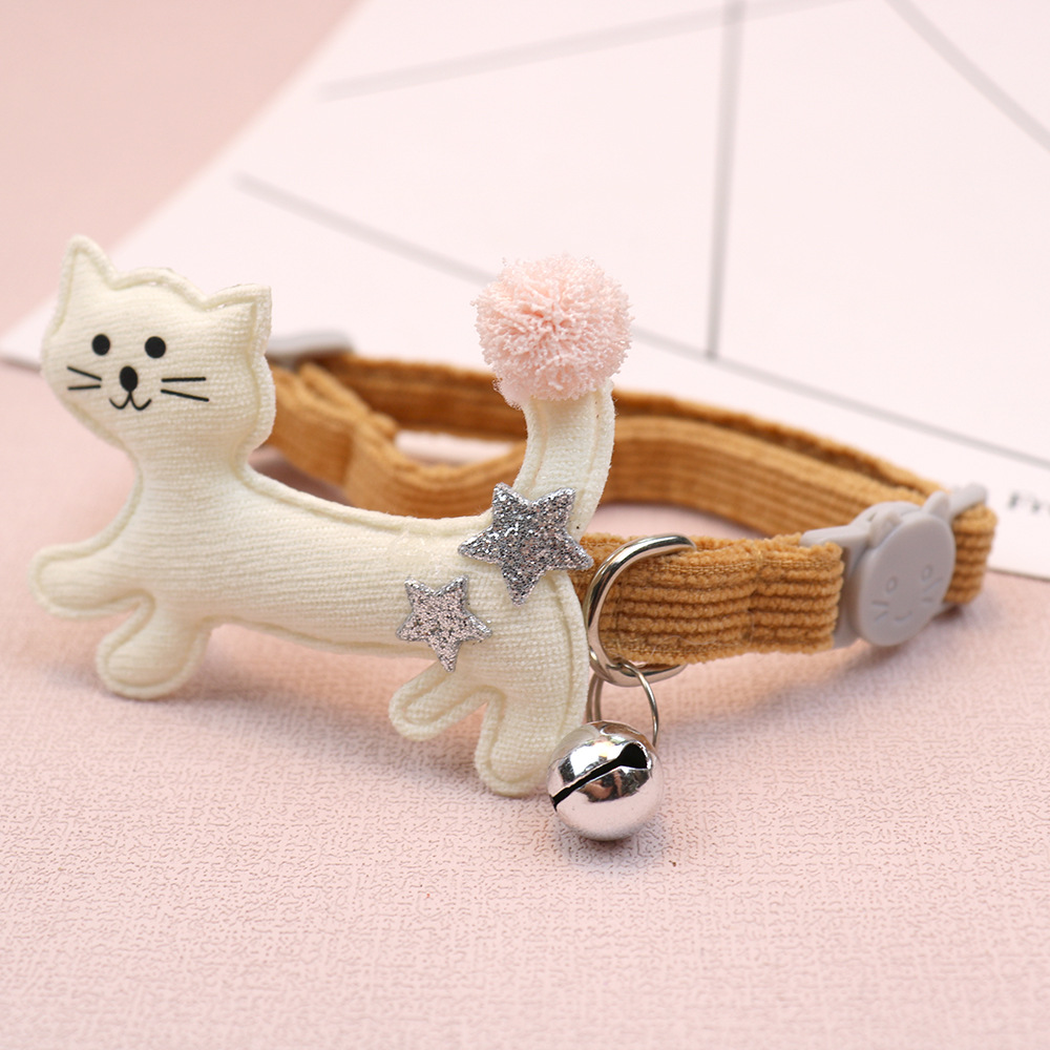 Close-up of an ivory cat applique, silver-tone D-ring and hanging bell