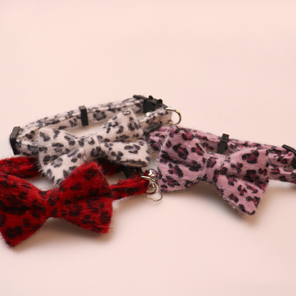 Close-up of red, light gray and pink leopard-print collar bows