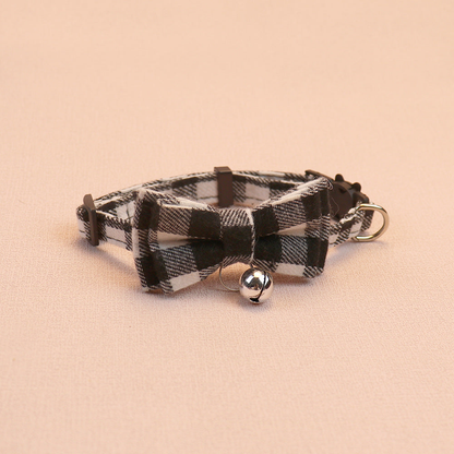 Black and white plaid bow cat collar with centered bell