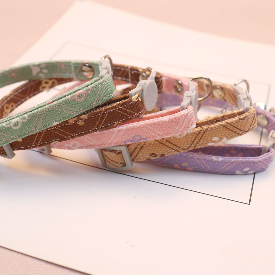 Side view of five patterned cat collars with adjustment sliders and cat-face buckles