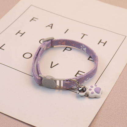 Light purple patterned cat collar with cat-face buckle, bell and paw-shaped charm