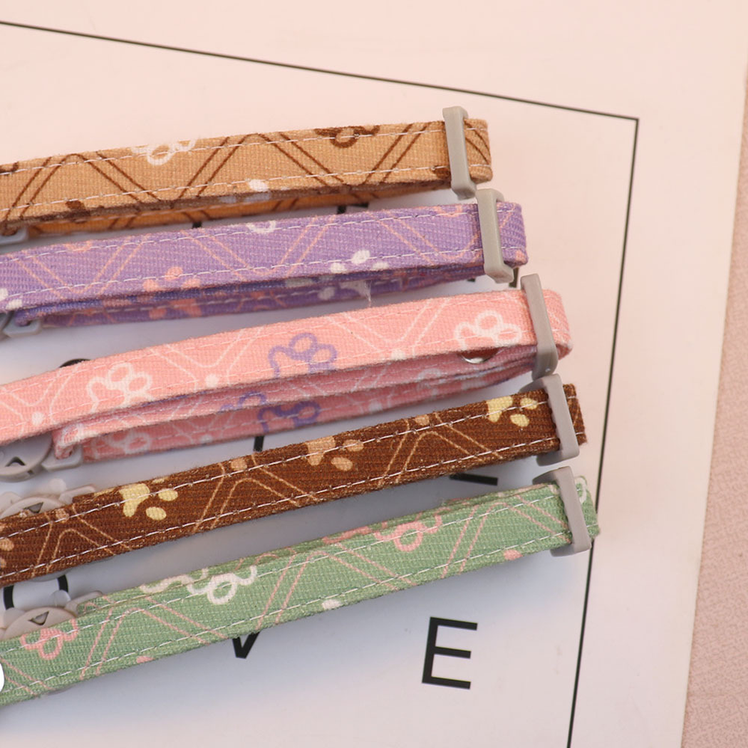 Close-up of five patterned collar straps with stitched edges and adjustment sliders