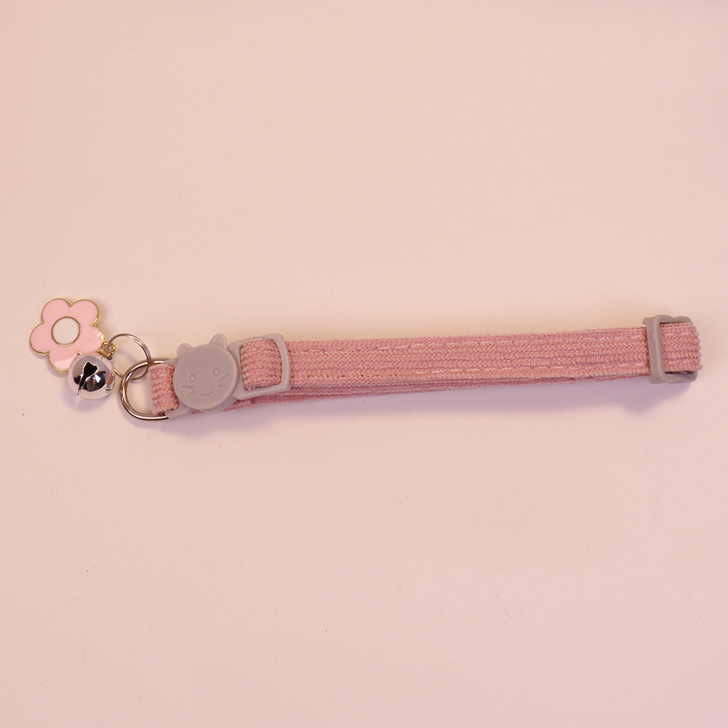 Pink cat collar with cat-face buckle, pink flower charm and bell