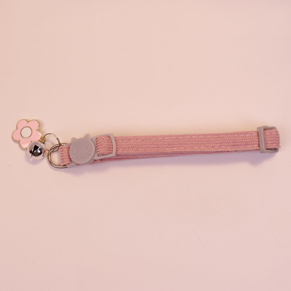 Pink cat collar with cat-face buckle, pink flower charm and bell